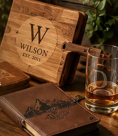 Engraved wooden cutting board, leather journal, and monogrammed whiskey glass
