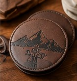 Leather coasters debossed with a mountain scene