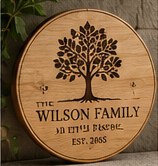 Round wooden family sign engraved with a tree